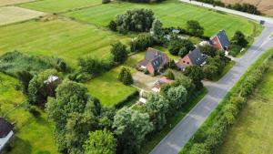 an aerial view of a house and a road at Wiesenhuus in Sankt Peter-Ording