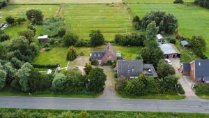 an aerial view of a house in a field at Wiesenhuus in Sankt Peter-Ording +8 photos