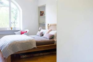 a bedroom with a bed with pillows and a window at Lesa villa near the lakeside in Lesa +20 photos