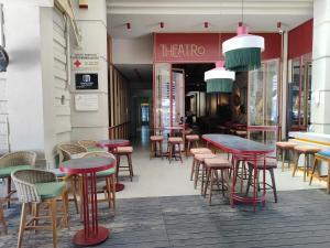 a group of tables and chairs in front of a store at The Square Point in Komotini