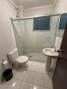 a bathroom with a shower and a toilet and a sink at Bravo City Hotel Campinas in Campinas