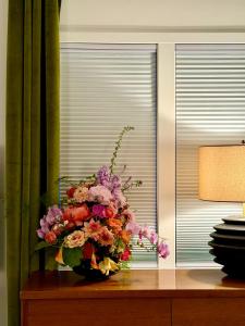 a vase of flowers sitting on a table at Alaskan Hideaway | Cozy & Adventure-Ready in Anchorage