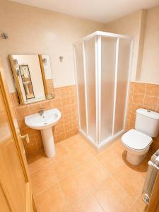 a bathroom with a shower and a toilet and a sink at Hostal Restaurante Portell in Portell de Morella +16 photos