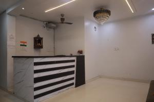 a white room with a black and white counter at Hotel Downtown in Kānpur