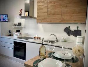 a kitchen with a table with wine glasses on it at Vercelli Civico 31 in Vercelli