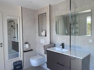 a bathroom with a sink and a toilet at La Petite Provence in Arbois