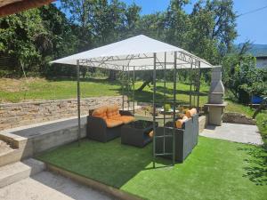 a gazebo with two couches in a yard at Kovaci Garden House in Sarajevo