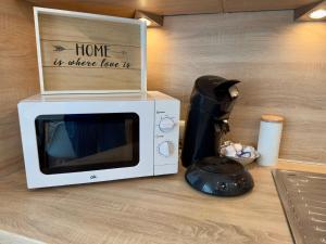 a microwave with a box on top of it on a counter at Ferienwohnung Stefan in Wallertheim
