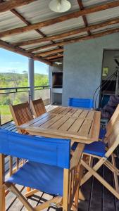 a wooden table and chairs on a deck at El Palmar in San Antonio de Arredondo