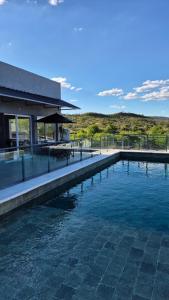 a swimming pool in front of a house at El Palmar in San Antonio de Arredondo +14 photos