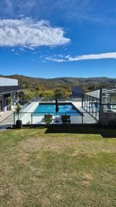 a house with a swimming pool in the middle of a yard at El Palmar in San Antonio de Arredondo