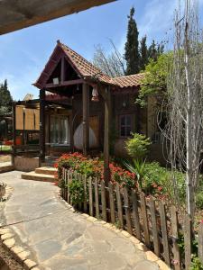 a small house with flowers in front of it at Fashet alsalt in Al Salt