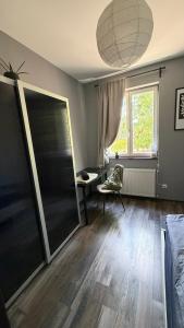 a living room with a large window and a chair at Rózsa Vendégház INGYENES PARKOLÁSSAL in Nagykovácsi