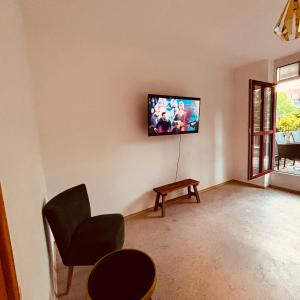 a living room with a flat screen tv on the wall at Dorey Home DEG1- Business-Apart l vollküche l WLan l Terasse bis 7 Personen in Deggendorf +17 photos