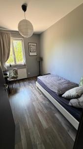 a bedroom with a bed and a window at Rózsa Vendégház INGYENES PARKOLÁSSAL in Nagykovácsi