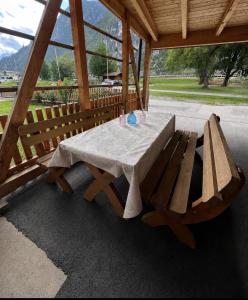 a picnic table and bench in a pavilion at Haus Antonia in Zams