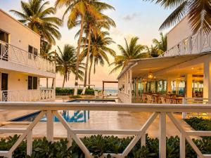 an exterior view of a resort with palm trees at Hotel San Luis Beach House By OxoHotel in San Andrés