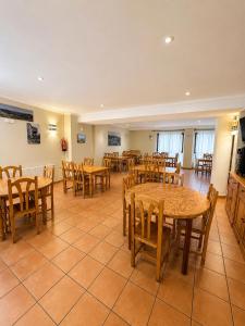 a dining room with wooden tables and chairs at Hostal Restaurante Portell in Portell de Morella