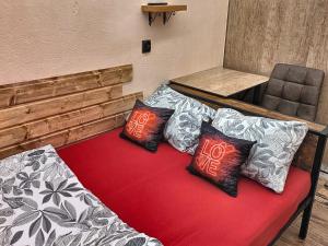 a couch with three pillows on it in a room at Podziemne Arkady-nocleg centrum blisko dworca in Gniezno +23 photos
