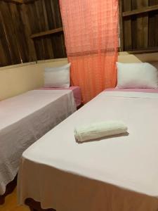 two beds sitting next to each other in a room at Quisqueya in Arroyo Chico Arriba
