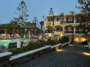 a hotel with a swimming pool and a resort at Santa Elena in Kamari +53 photos