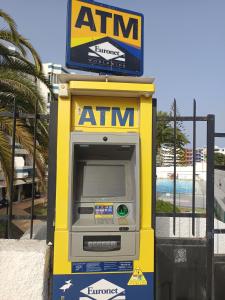 an atm machine with a sign on top of it at Teror Playa in Playa del Ingles