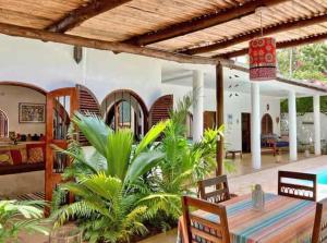 a dining room with a table and chairs in a house at Casa del Mar Diani in Diani Beach