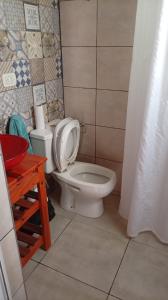 a bathroom with a white toilet and a sink at MALU casa quinta in Rafaela +12 photos