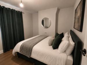 a bedroom with a large bed and a mirror at 3 Bed House , Bootle , Discounts , Long Stays , Contractors , Families , Relocation Stays in Liverpool