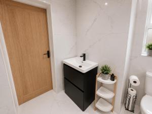 a bathroom with a sink and a toilet at 3 Bed House , Bootle , Discounts , Long Stays , Contractors , Families , Relocation Stays in Liverpool