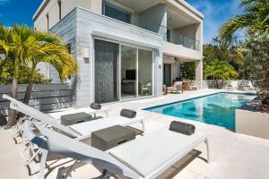 a villa with a swimming pool and a house at Second Wind Villa in Long Bay Hills