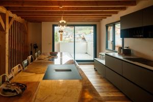 a kitchen with a table in the middle of a room at Le val'heureux in Valloire