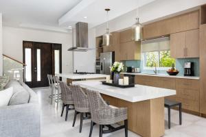 a kitchen with a island with chairs and a counter top at Second Wind Villa in Long Bay Hills +20 photos