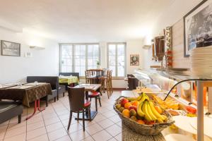 a restaurant with a bowl of fruit on a counter at Hôtel de La Vallée in Ornans