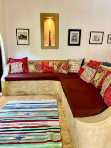 a couch with colorful pillows on it in a room at Casa del Mar Diani in Diani Beach