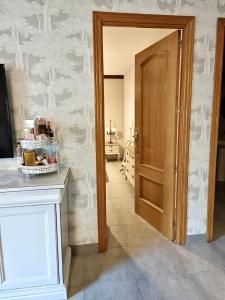a room with a hallway with a door and a table at El Rinconcito de La Suiza in Robledo de Chavela