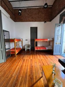 a room with two bunk beds and a wooden floor at Malala in Buenos Aires