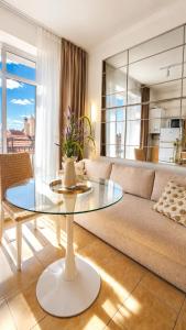 a living room with a glass table and a couch at Central City Balcony Apartments in Mukacheve