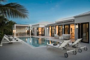 a villa with a swimming pool and a house at Villa Seadream - Upper East Side Enclave #16 in Long Bay Hills