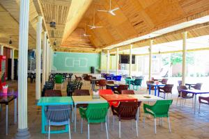a cafeteria with tables and chairs in a building at JOSEPHINA LODGE Dodoma in Dodoma