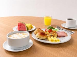 a table with a bowl of soup and a plate of food at Alko Select in Cali
