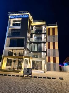 a building with a bench in front of it at night at Daviel Elite Apartments in Dodoma
