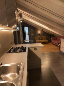 a kitchen with a sink and a stove in a room at Lange in Priocca
