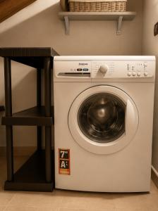 a white washing machine sitting next to a shelf at Lange in Priocca