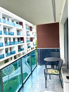 a balcony with a table and chairs in a building at The Nest in Otopeni