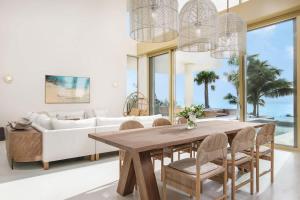 a living room with a table and a couch at Kailoa Villa in Long Bay Hills