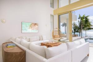 a living room with a white couch and a table at Kailoa Villa in Long Bay Hills