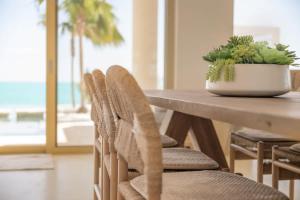a table with chairs and a potted plant on it at Kailoa Villa in Long Bay Hills +43 photos
