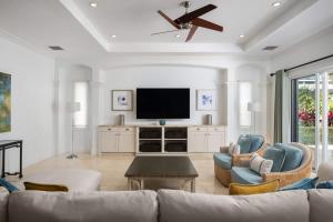 a living room with a couch and a flat screen tv at Abundance and Prosperity Villa in Long Bay Hills