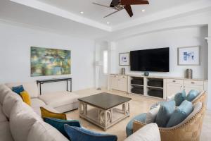 a living room with a couch and a tv at Abundance and Prosperity Villa in Long Bay Hills